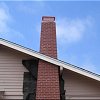 Custom Masonry Tapering Brick Chimney with chimney cap and copper spark arrestor