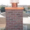 Custom Masonry Brick Chimney with copper chase cover and spark arrestor
