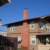 Custom Masonry Brick Chimney with brick corbels just below chimney cap and spark arrestor