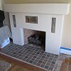 Custom Plaster Fireplace with mosaic tile hearth and inlaid Batchelder tiles