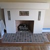 Custom Plaster Fireplace with mosaic tile hearth and inlaid Batchelder tiles