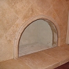 Travertine Tile Face Fireplace and raised hearth - decorative tile arch